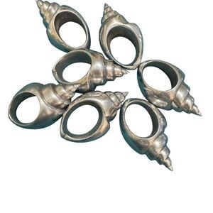 Set of 7 silver toned aluminum conch shell napkin rings